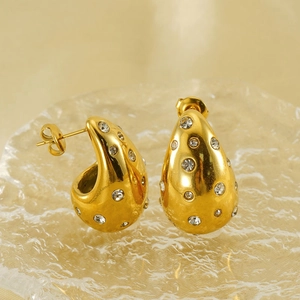 Elegant 18K gold-plated teardrop earrings with sparkling white zircons on textured glass