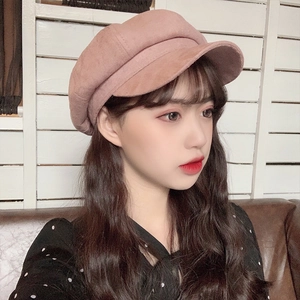 Detail of pink-brown suede octagonal baker boy hat worn by a model in soft lighting