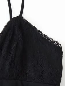Detailed macro view of black lace stitching and sheer mesh on the V-neck shoulder strap
