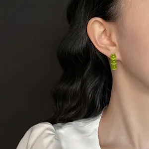 Elegant emerald green cat eye stone drop earrings with three beads in gold finish