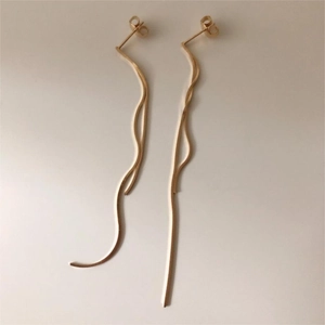 Detail view of 925 sterling silver long snake chain tassel earrings in gold finish