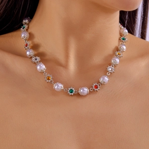 Hip hop pearl necklace with colorful gemstone flower motifs shown on a model neck