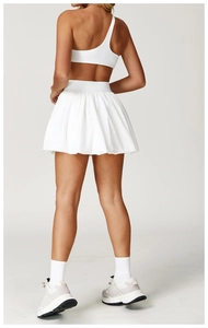 Detail of white pleated tennis skirt with breathable fabric and athletic cut