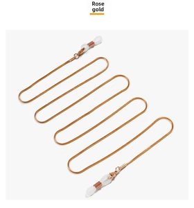 Detail of rose gold snake chain eyeglass strap with white silicone rubber loop ends
