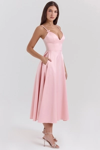Detail of pink satin V-neck maxi dress showing side pocket design and smooth fabric texture