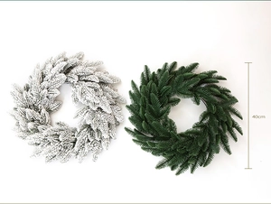 Detail showing 40cm artificial Christmas wreaths in green and flocked snow versions