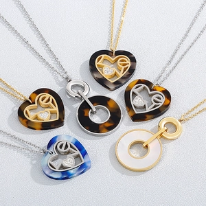 Golden round shell pendant necklace with LOVE lettering and heart-shaped elements