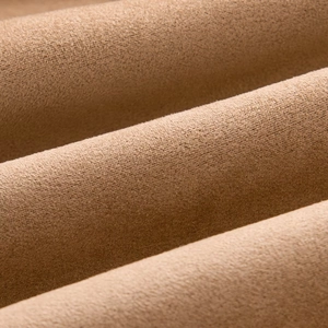 Macro detail of camel faux suede fabric texture showing soft fuzzy material surface