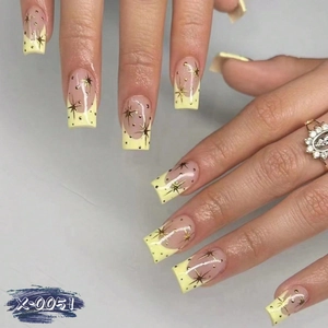 Handmade French press-on nails in long square shape with yellow tips and star designs