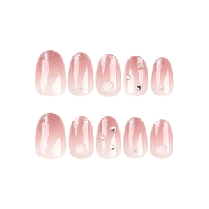 Pink gradient press-on nails with silver glitter tips, pearls, and 3D heart charms