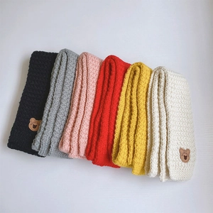 Detail of soft knit scarf sets in multiple colors with cute bear leather patch accents