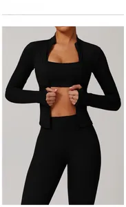 Detailed view of black zip-up fitness jacket with thumbholes and high waist yoga leggings