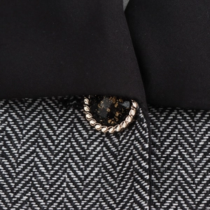 Elegant blazer suit with contrast collar and gold braided button on tweed fabric