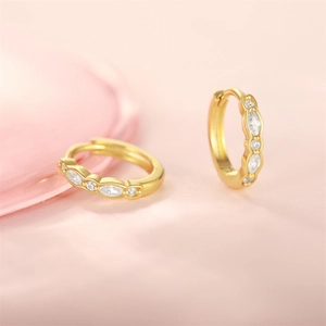 Detail of gold-plated hoop earrings with marquise and round cubic zirconia stones