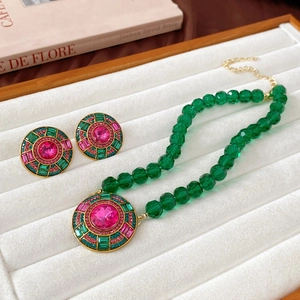 Vintage French gold-plated jewelry set with green beads and pink crystal circular studs