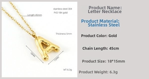 Macro view of gold bubble letter A pendant with 18K PVD coating on stainless steel chain