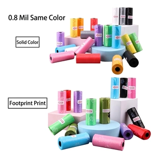 Biodegradable pet waste bags in solid colors and paw prints shown on display stands