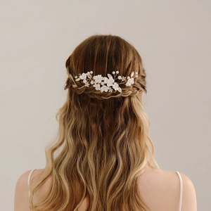 Detail of handcrafted bridal hair comb with ceramic flowers and pearls on model