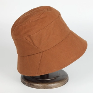 Japanese style caramel cotton bucket hat for women on a wooden stand for sun protection