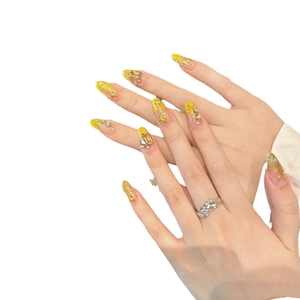 French cat-eye press-on nails with luxury gold glitter and metallic flower accents