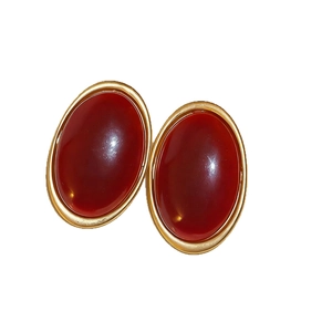 Vintage oval resin stud earrings in deep red with elegant golden metallic frames