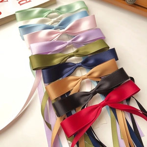 Colorful satin ribbon bow hair clips with long streamers in various vibrant shades