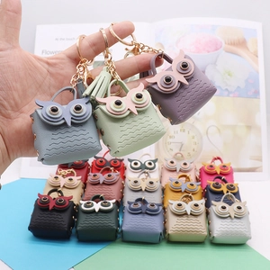 Detail showing colorful PU leather owl keychains with textured finish and golden clasp