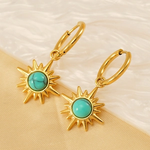 Bohemian gold hoop earrings with turquoise sunburst charms on elegant silk fabric