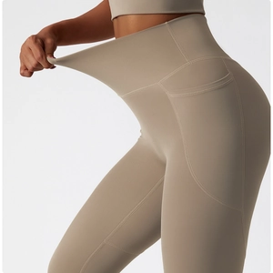 Detail of high waist yoga pants showing stretch elasticity and side pocket functionality