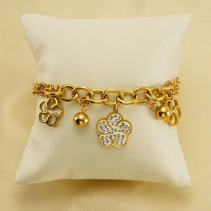 Bracelet en acier inoxydable plaqué or 18 carats avec fleurs évidées et strass blancs