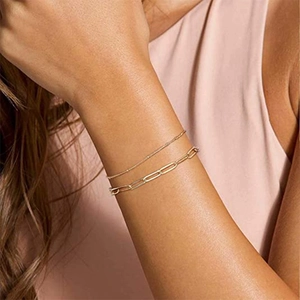Double-layered gold paperclip and bead chain bracelet set for a minimalist aesthetic