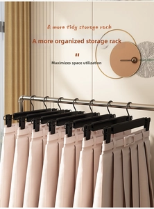 Adjustable black plastic clothes hangers with clips for organized closet skirt storage