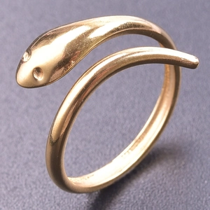Macro view of gold snake ring featuring textured head and minimalist wrap design
