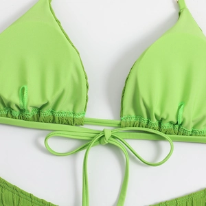 Detail of neon green ribbed bikini top with adjustable front drawstring bow tie
