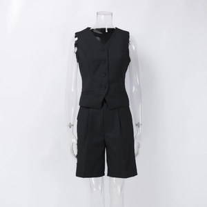 Detailed front view of black V-neck buttoned vest and matching tailored suit shorts set