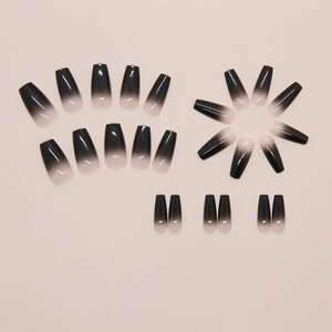Macro detail of 24pcs long coffin press-on nails with black ombre gradient and glossy finish