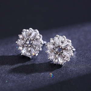 Elegant S925 silver flower stud earrings with sparkling crystals on a dark surface