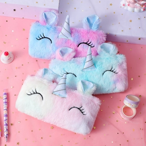 Detailed view of plush unicorn pencil cases with glitter horns and soft rainbow fur texture