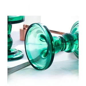 Macro shot of vintage dark green glass candle holder with smooth polished texture