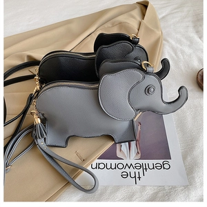 Close-up of elephant-shaped PU leather crossbody bags in grey and black with tassels