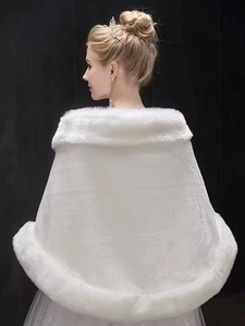 Detail of white faux fur bridal shawl with soft textured trim for winter weddings