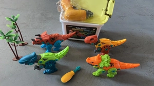 Detailed view of the take apart dinosaur toy set with electric drill and storage box