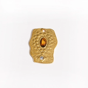Detail of gold rectangular pendant with hammered texture, tiger eye stone, and rhinestone