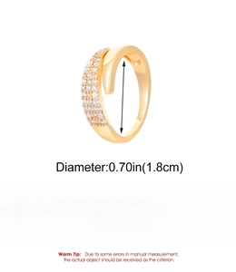 Detail view showing a 1.8cm diameter gold spiral ring made of copper with CZ inlay