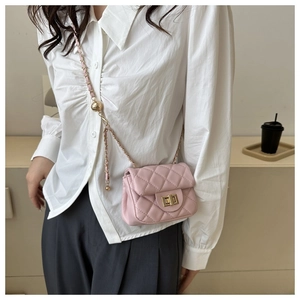 Pink quilted crossbody bag with gold chain strap and metal ball slider detail