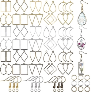 Macro detail of geometric metal frame charms with floral resin pendants for DIY jewelry