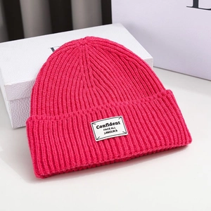 Detailed knit texture and patch of the magenta winter beanie on white display