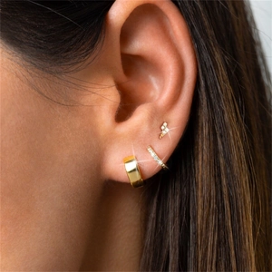 Close-up of 3-piece turquoise silver earring set including lightning stud and gold hoops