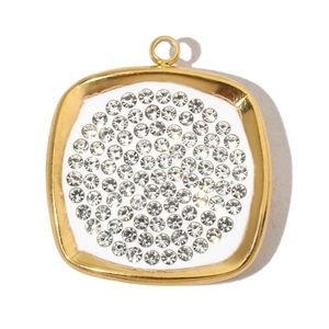 Detail of square gold pendant featuring a central circle of sparkling white crystals
