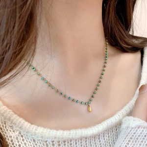 Elegant 18K gold teardrop pendant necklace with turquoise beads on a dainty chain